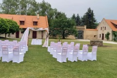 Uspořádání židlí pro svatební hosty na trávníku zámku Libouchec.
